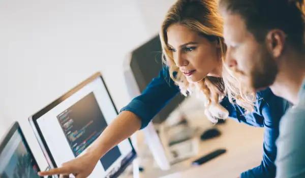 Man and woman looking at screen
