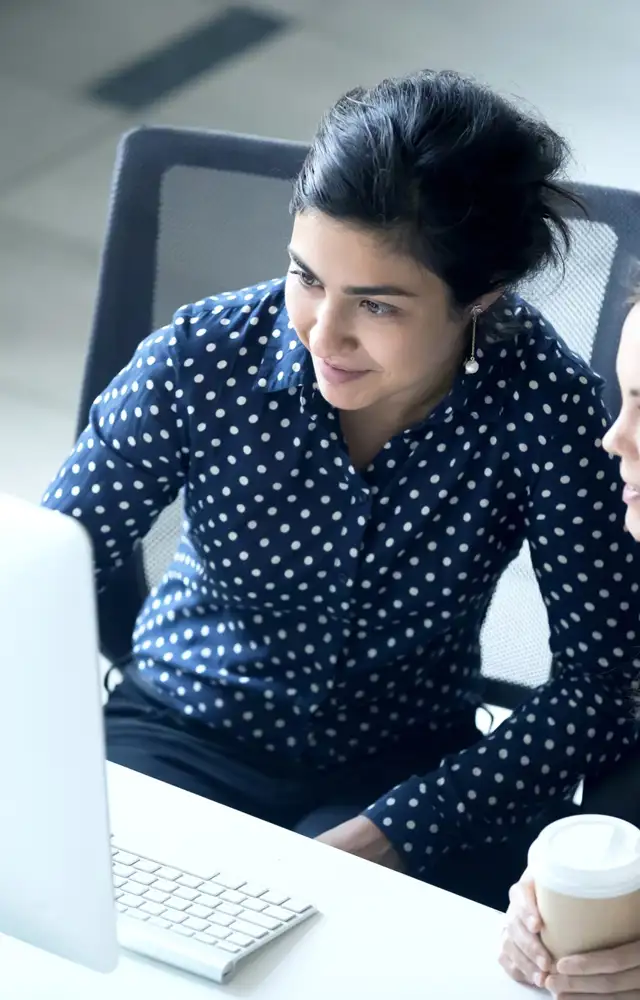Two woman looking at a computer screen