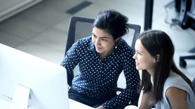 Two woman looking at a computer screen