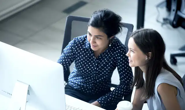 Two woman looking at a computer screen