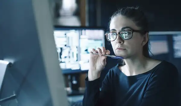 Woman looking focused while working on a computer screen