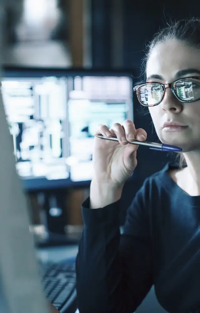 Woman looking focused while working on a computer screen