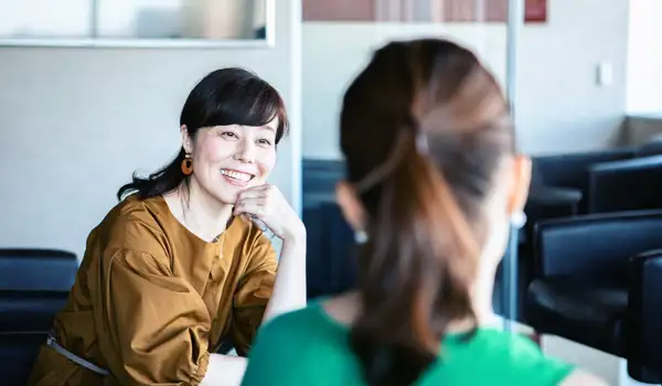 Happy women having a conversation in the office