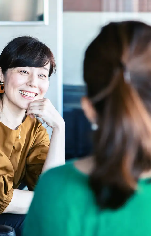 Happy women having a conversation in the office