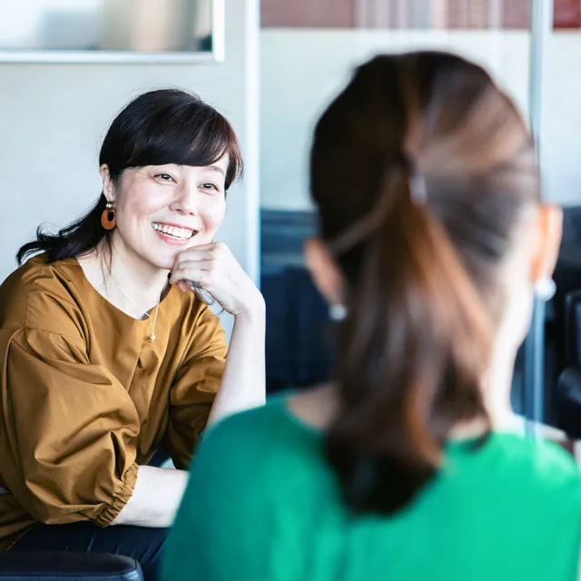 Happy women having a conversation in the office