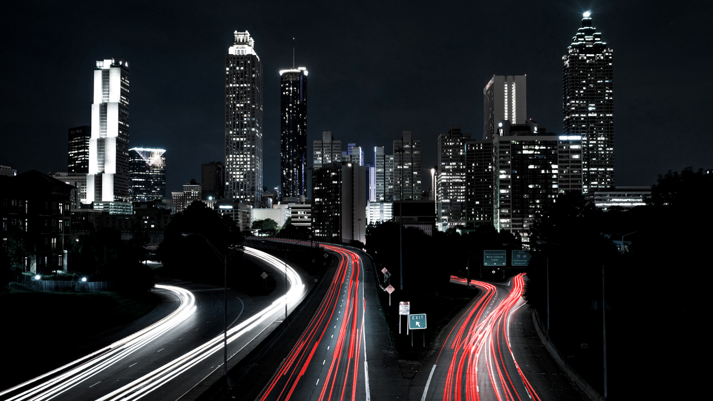 Road at night with break lights large city