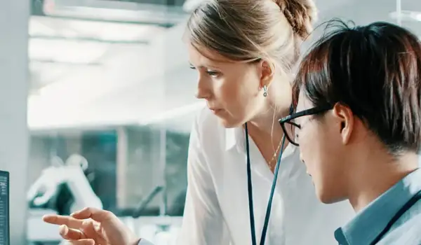 Two people discussing something on a screen