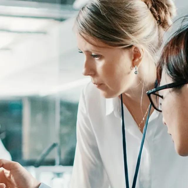 Two people discussing something on a screen