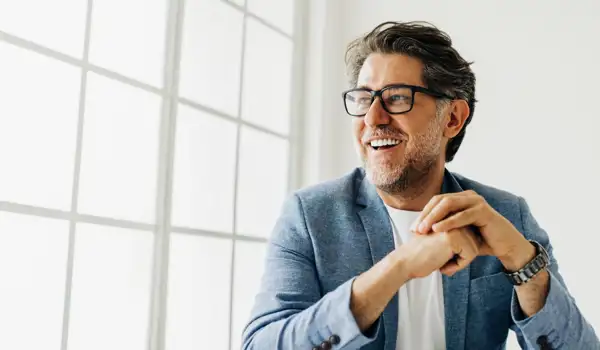 Happy man setting at a window