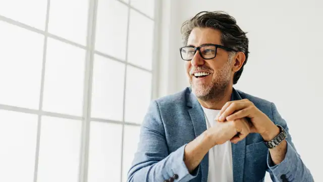 Happy man setting at a window