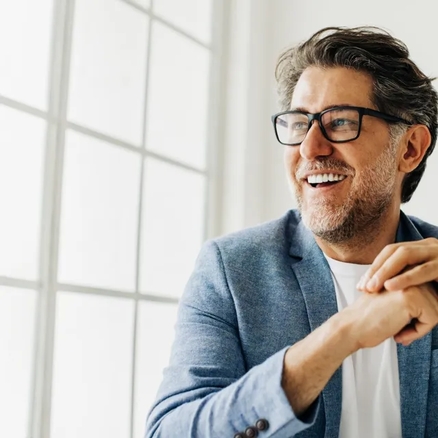 Happy man setting at a window