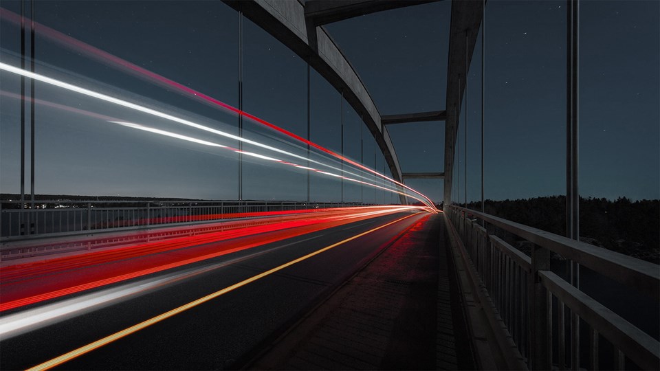 Car lights on bridge at night