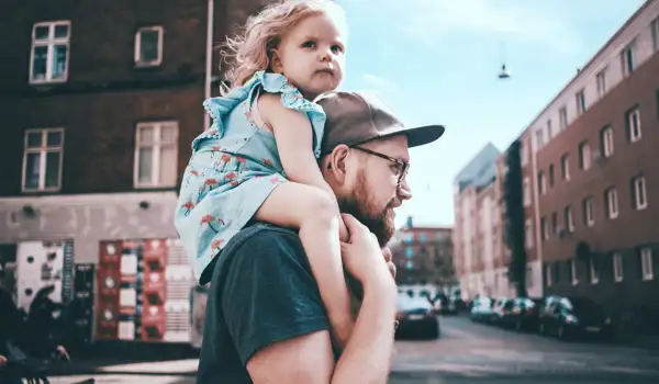 Father and daugther walking the street