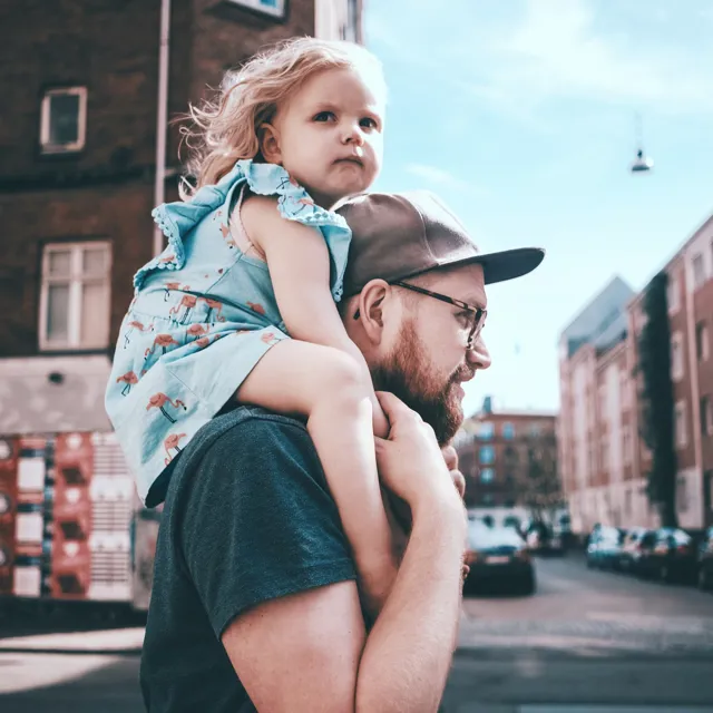 Father and daugther walking the street
