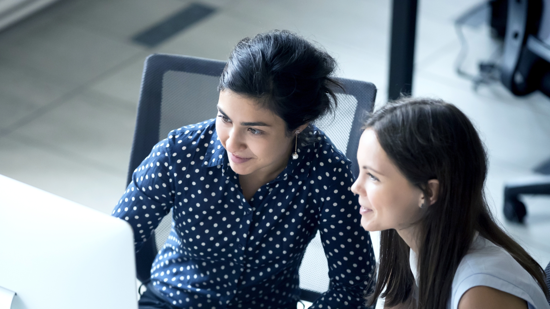Advisory And Consulting Two Women Looking At Screen