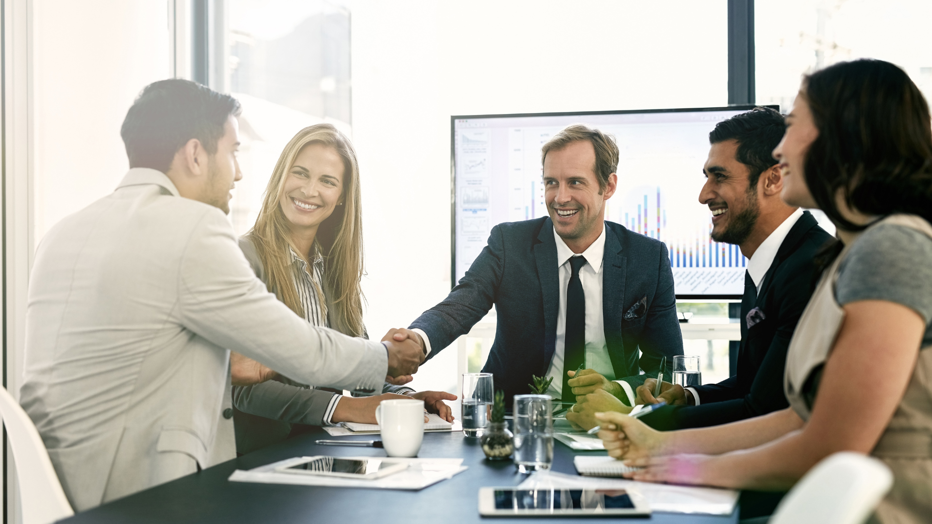 Business consultants meeting with clients to plan digital transformation strategy and enterprise technology solutions.