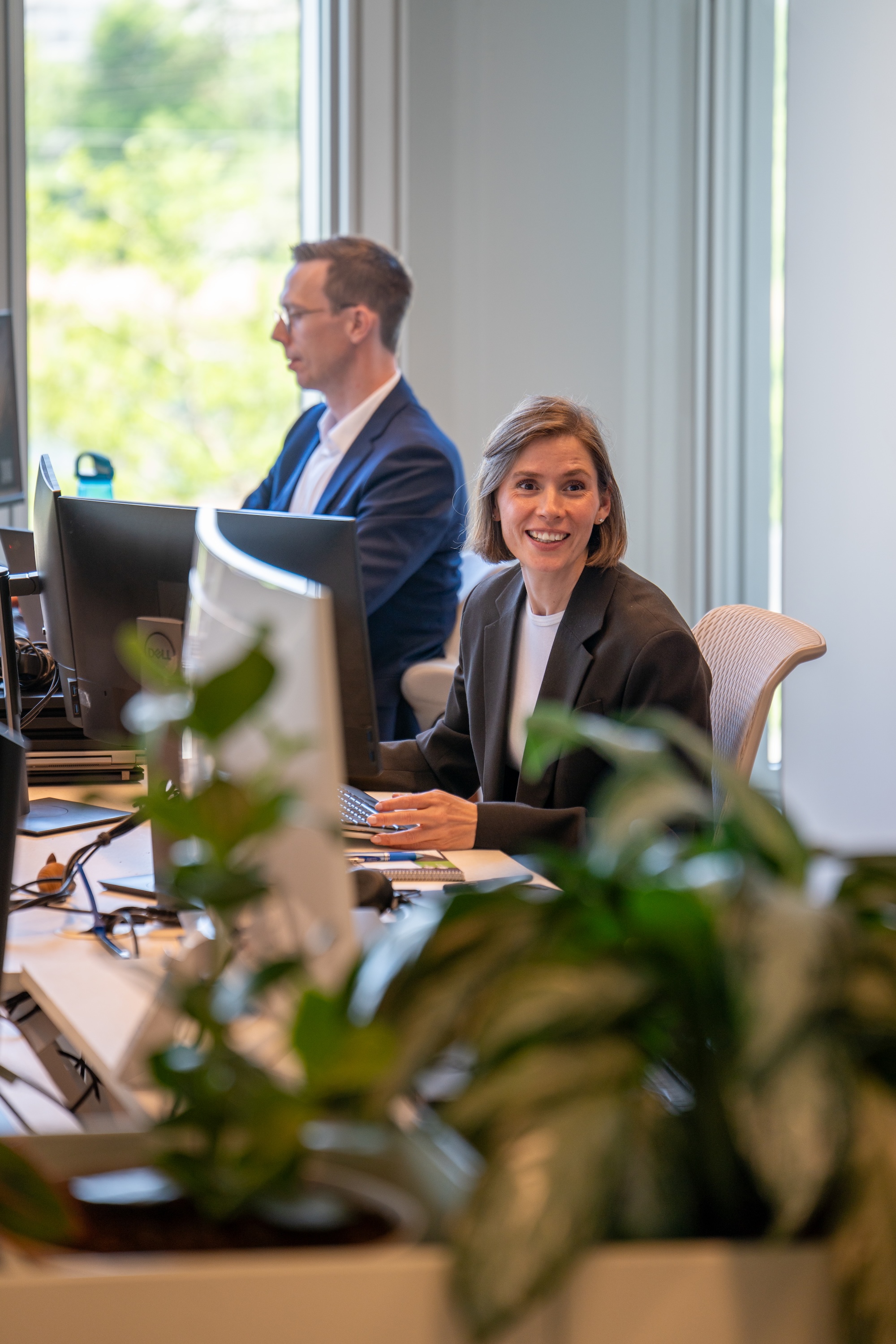 NNIT consultants working at desks on solutions for regulated industry clients.