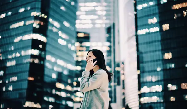 Woman talking on the phone next ty skyscrapers