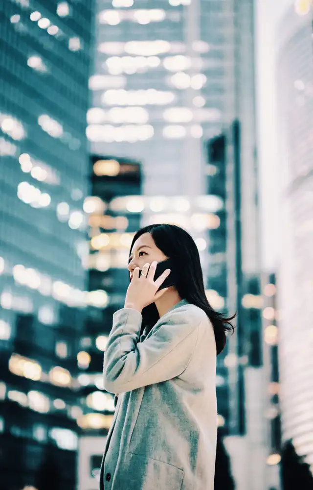 Woman talking on the phone next ty skyscrapers