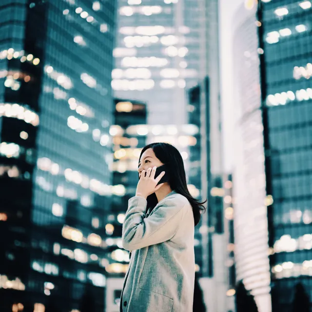 Woman talking on the phone next ty skyscrapers