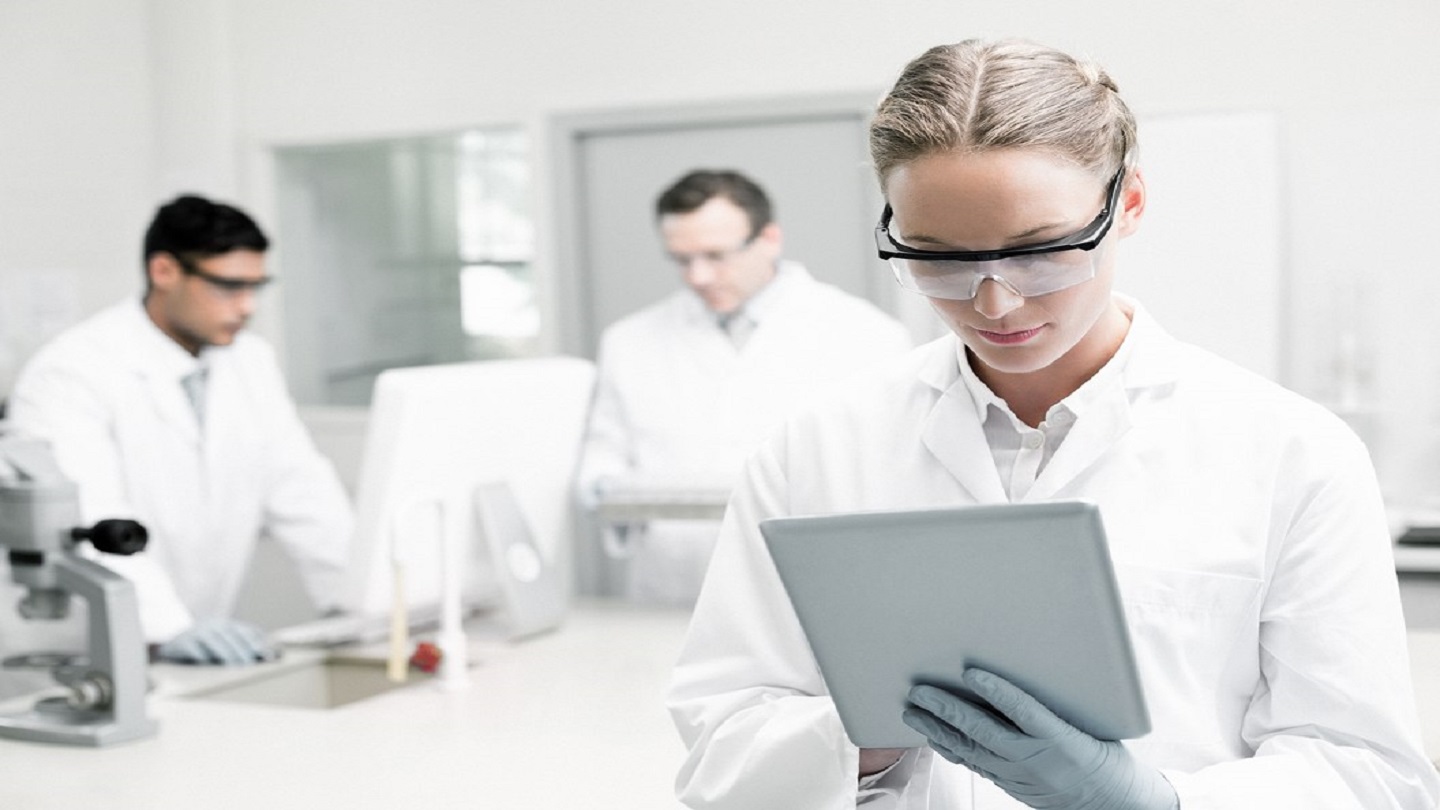 Woman looking at tablet computer in lab