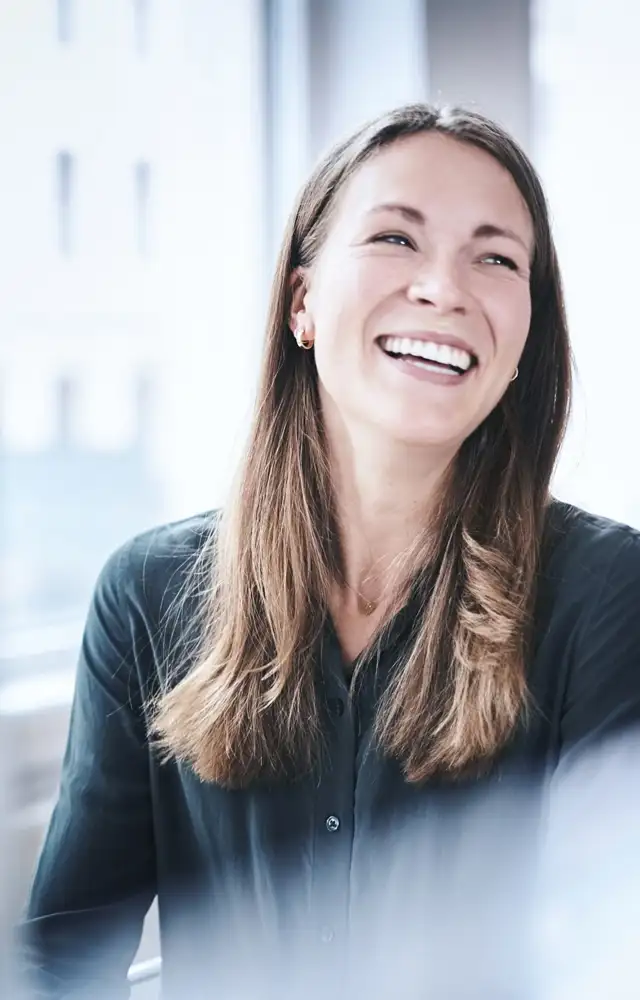 Happy woman at her work station in the office