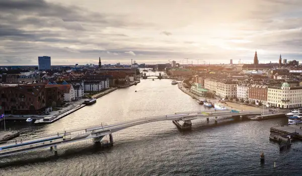 A bridge over the water in a busy city