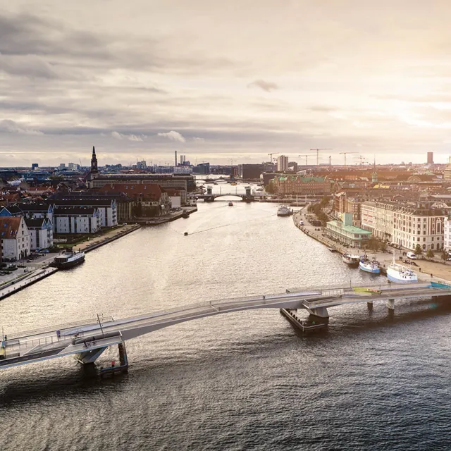 A bridge over the water in a busy city