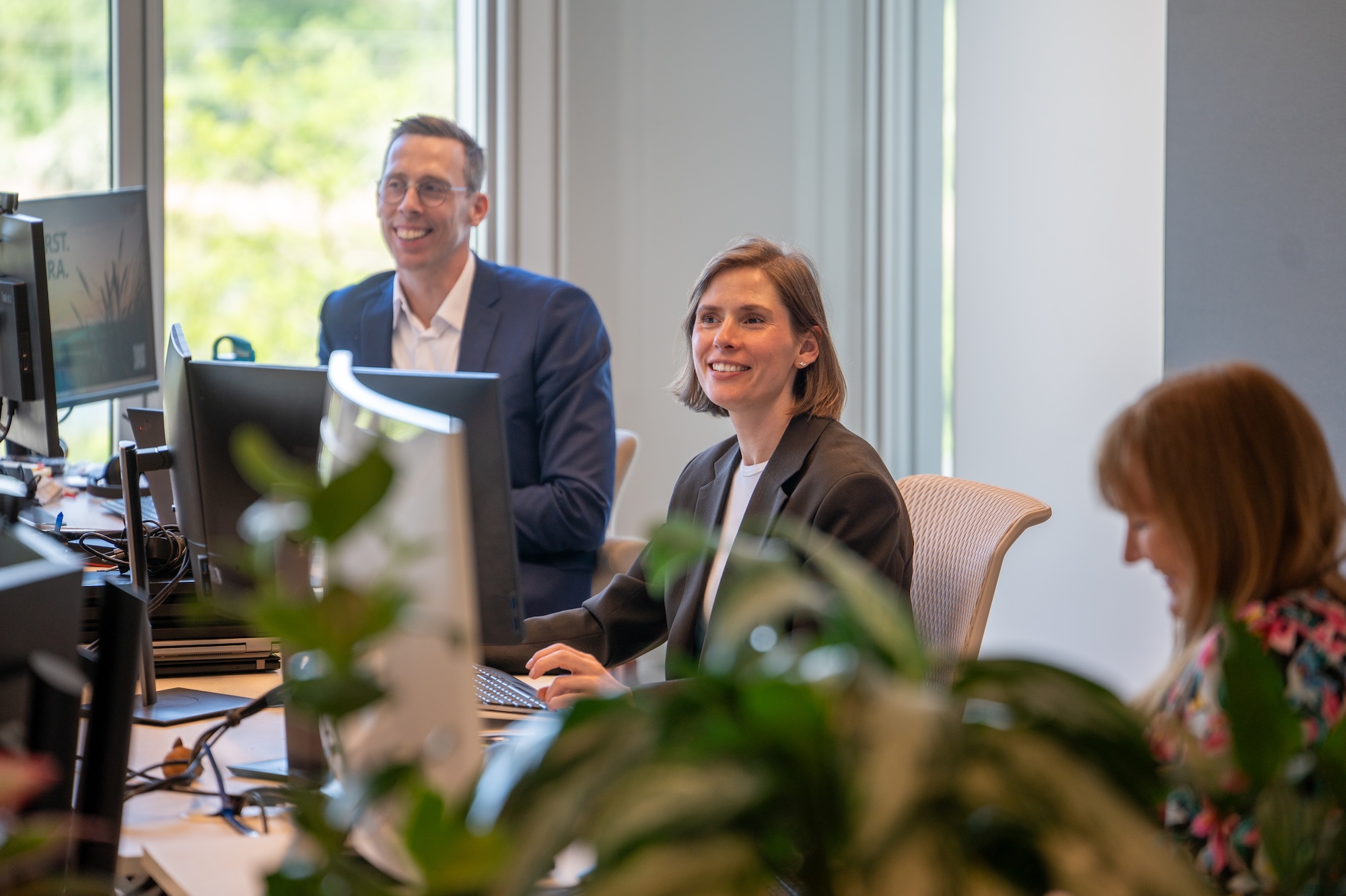 NNIT colleagues working together in a modern office focused on regulated industries.
