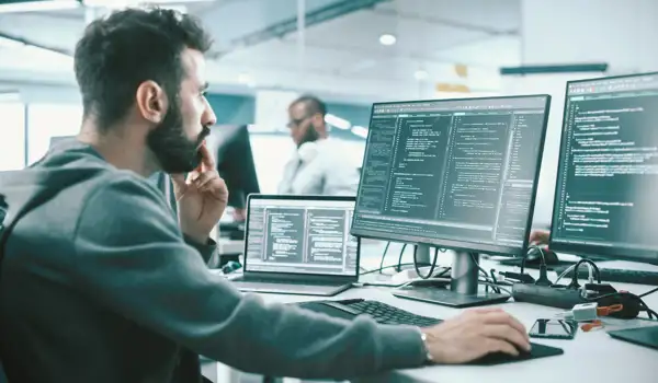 Man sitting in a office environment coding