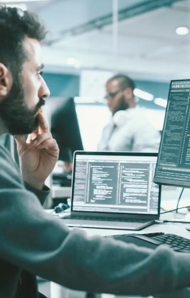 Man sitting in a office environment coding