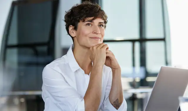 Woman setting a at desk looking interested