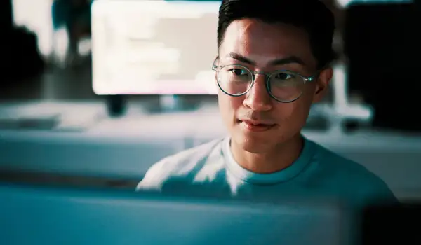 Guy with glasses sitting in a office