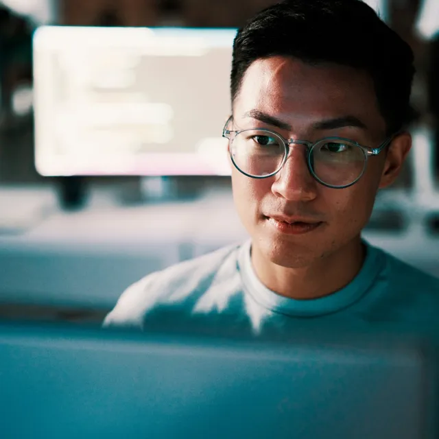 Guy with glasses sitting in a office