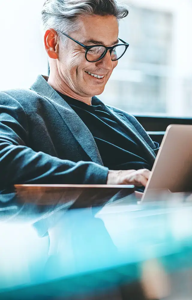Man smiling at computer