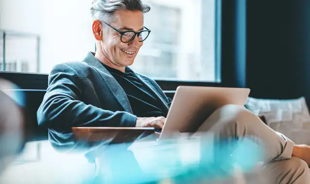 Man smiling at computer
