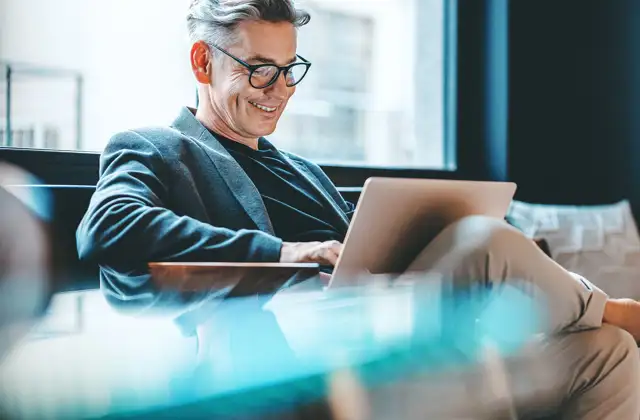 Man smiling at computer
