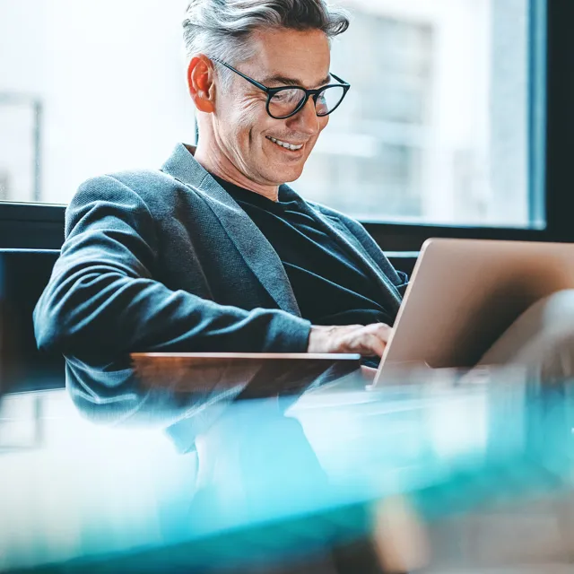 Man smiling at computer